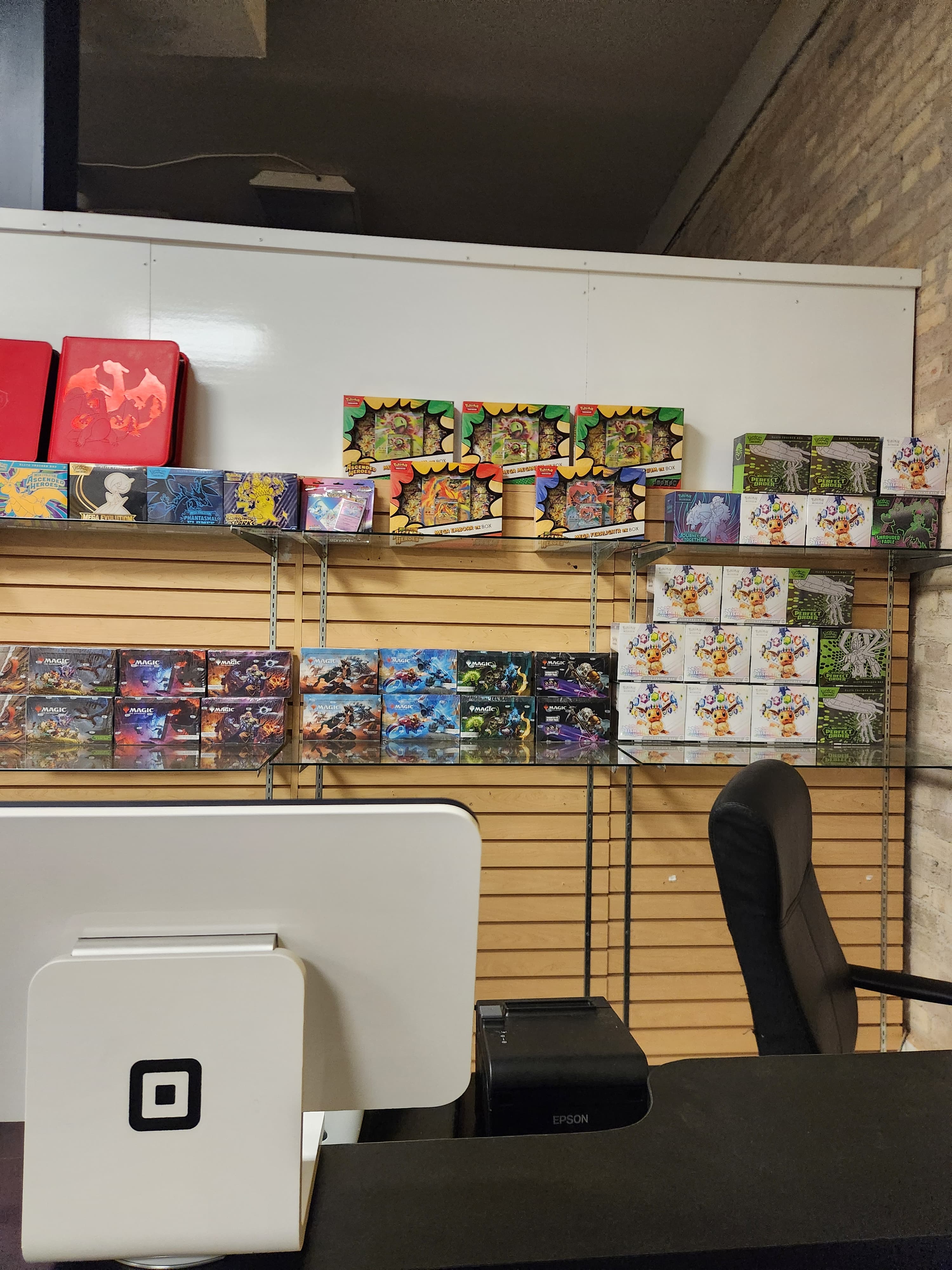 Wide interior view of The Wolf Den storefront with shelves, display cases, and counter area
